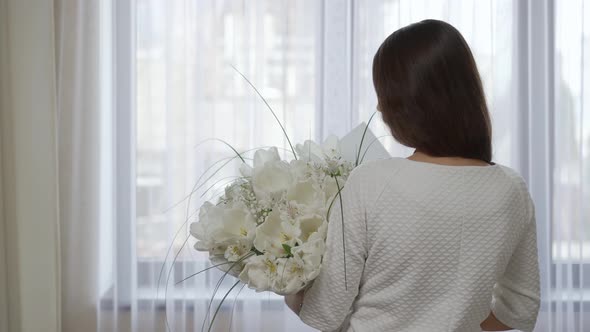 Woman with Bouquet of White Flowers