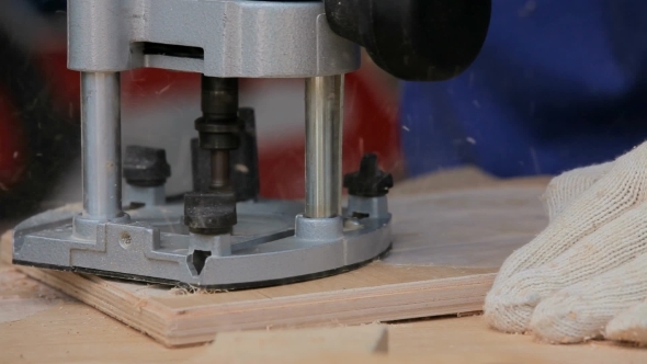 Work Carpenter With An Electric Hand-Milling