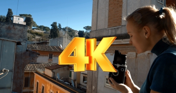 Woman With Retro Camera On The Balcony