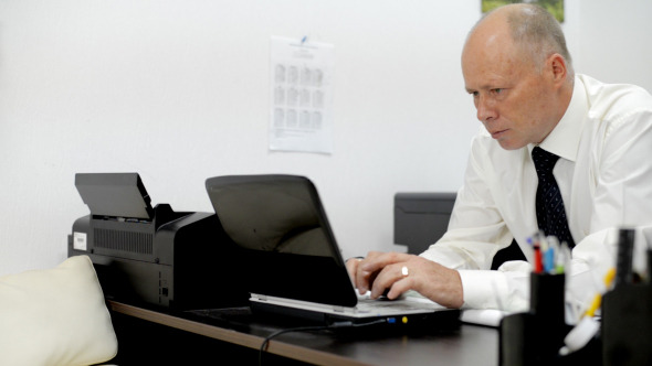 Man Typing on Laptop