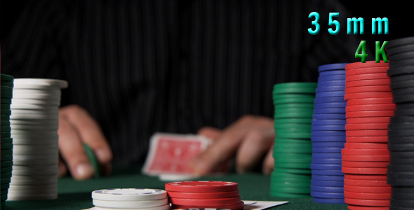 Poker Chips And Player Looking At His Cards 02 