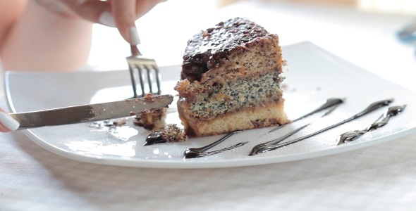 The Girl Eats A Sweet Cake In Restaurant alt