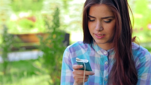 Beautiful Girl In Park With Her Phone/player alt