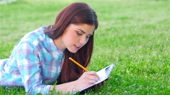 Beautiful Girl With Her Diary In Park
