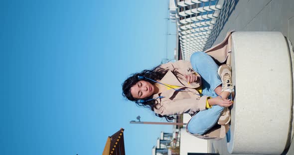 Vertical  Footage of a Young Asian Woman Meditates on the Embankment