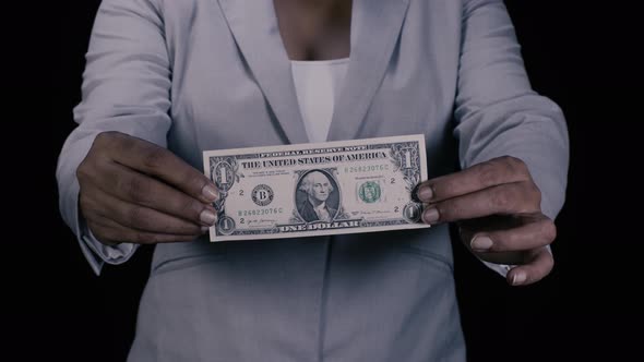 Office Woman Holds Up Dollar Bill 