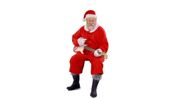 Santa claus singing a song and playing guitar