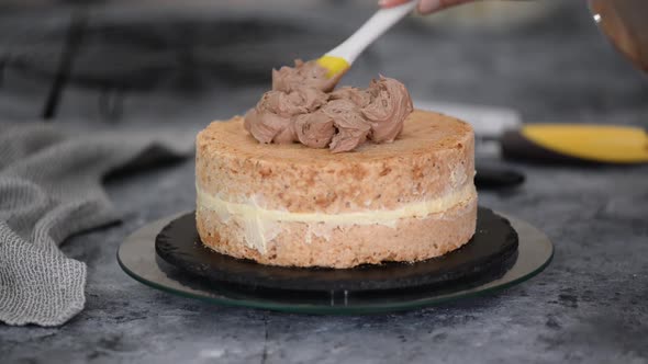 Close Up of Woman Hands Making Sweet Kiev Cake with Buttercream