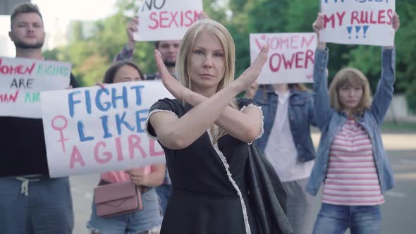 Confident Caucasian Woman Crossing Hands in No Gesture on Demontration Against Sexism and Women