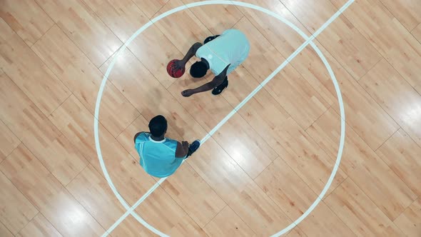 Two African Ethnicity Players are Having a Basketball Practice in a Top View