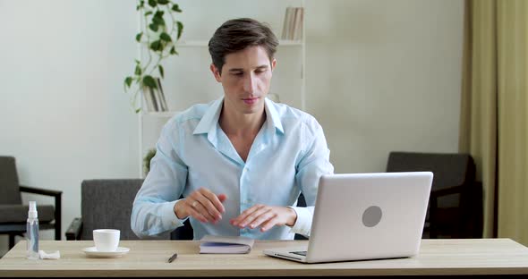 Serious Concentrated Businessman Leader Types on Laptop Keyboard, Looks at Computer Screen, Making