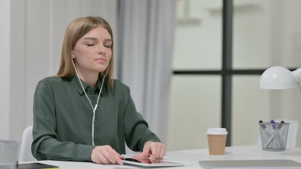 Young Woman Meditating with Music on Smartphone 