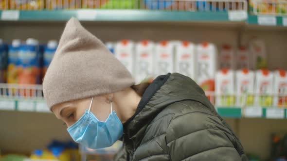 Woman in Medical Mask Shopping at the Supermarket