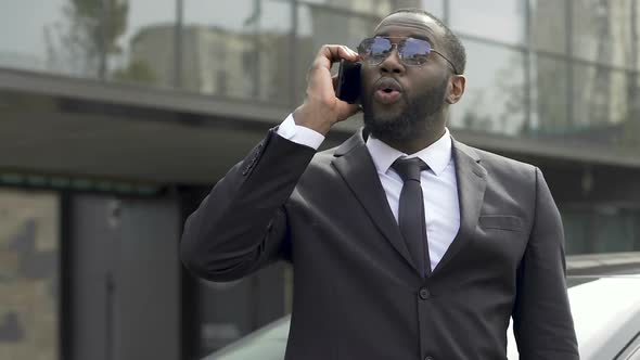 Afro-American Oligarch Discussing by Phone Purchase of Business Center, Wealth