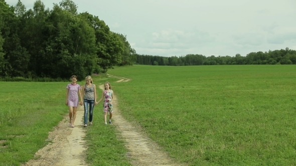 Mother And Daughters Walking Holding Their Hands alt