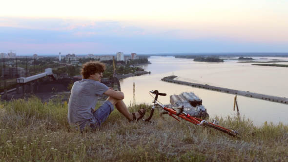 Man on a Bicycle Looking at Sea