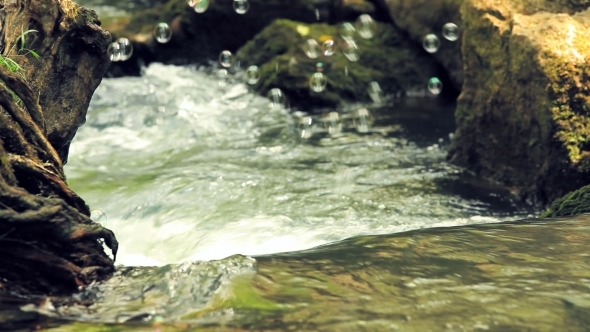 Soupbubbles Above Flowing Water Of River Stream