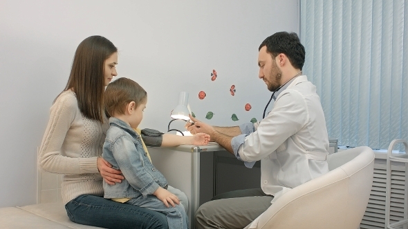 Doctor Measuring Blood Pressure Of a Child In