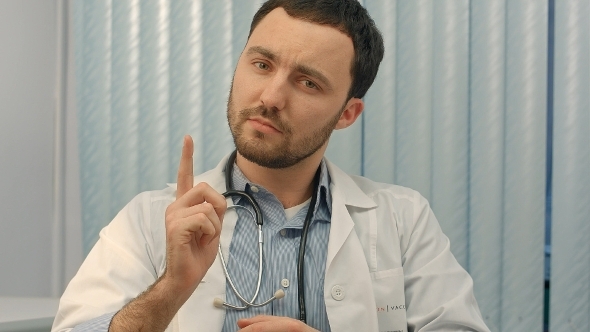 Doctor Pointing Above His Head Towards Blank White