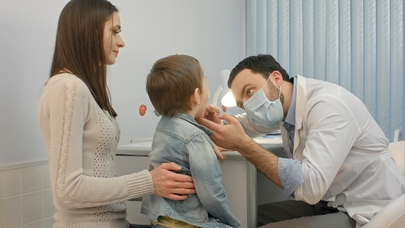 Pediatrician Checking Little Boy Throat