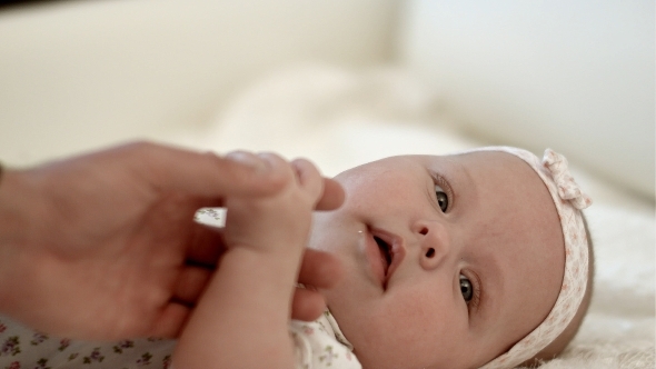 Happy Mother Holding Her Baby Hand alt