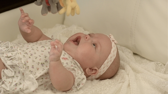 Happy Baby Playing With Bed Side Toy, Smiling alt