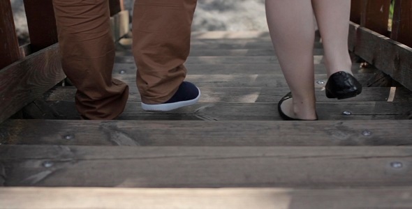 Man And Woman Walking Down The Stairs