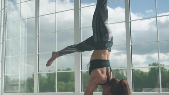 Wellness, Young Female Performs Stretching and Doing Yoga in a White Room Filled with Light