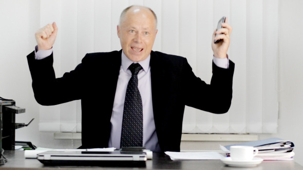 Excited Businessman on Phone