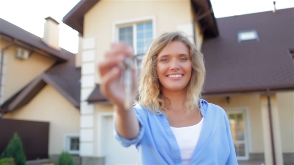 Happy Girl With Keys Next To Her New House alt
