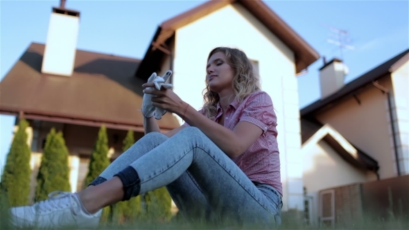 Beautiful Girl Sitting In The Yard