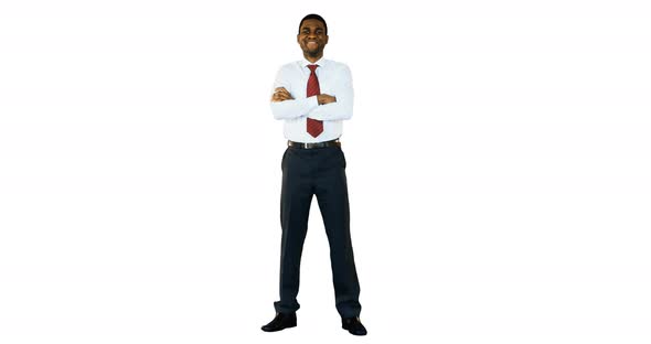 Portrait of smiling businessman standing with arms crossed