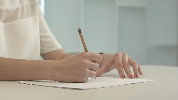 Woman With Pencil Writing On Paper