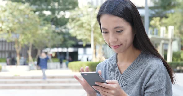 Woman use of smart phone in city