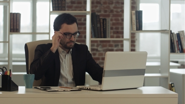 Businessman In Funny Glasses Typing On Keyboard