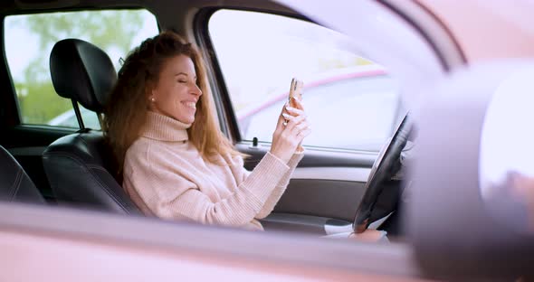 A 30Yearold Woman Communicates with Her Boyfriend Online Messages Via Smartphone in a Car in a