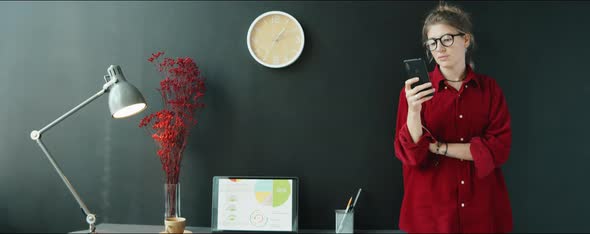 Businesswoman Using Phone in Modern Office