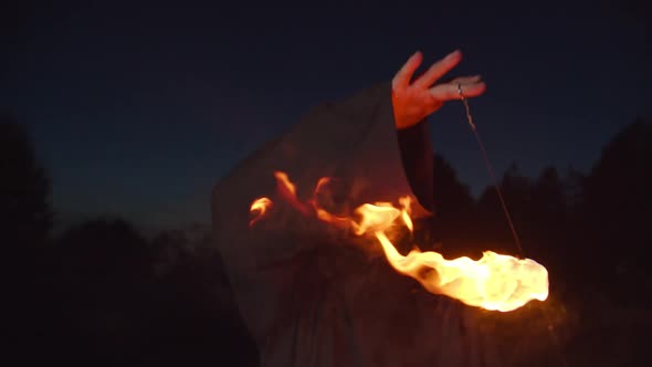 Eerie Angel of Death Conjuring Fireball at Dusk