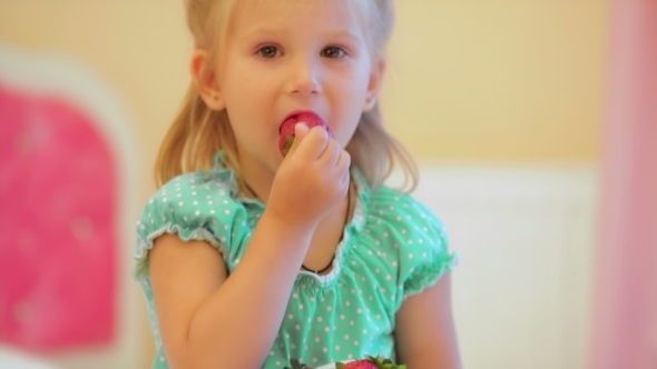 Adorable Little Girl Eating Strawberries alt