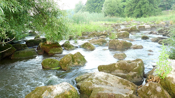 Fast Flowing River With Stones In The Water