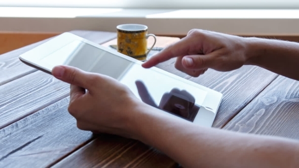 Working On Tablet Pc On Wooden Desk