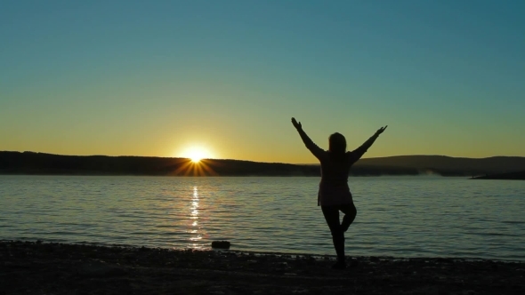 Pregnant Woman At Dawn Doing Exercise.