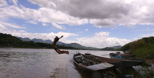 Boy Jumping From A Boat