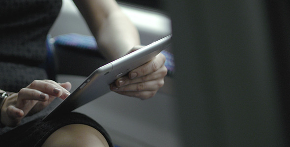 Woman With Touch Pad Tablet On The Go