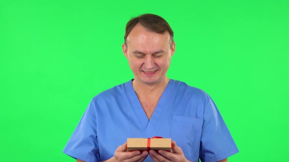 Medical Man Gives a Gift. Green Screen