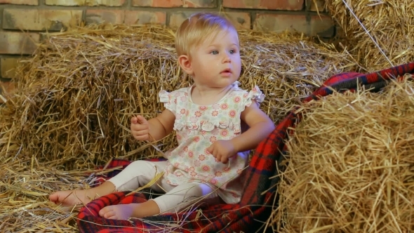 Small Child In A Haystack