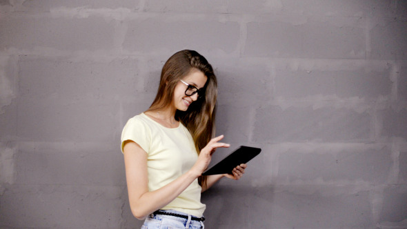 Girl Typing on Tablet