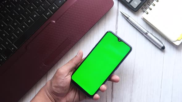 Top View of Man Hand Using Smart Phone on Office Desk