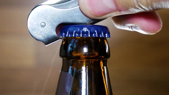 Bartender opening beer bottle in macro close up view