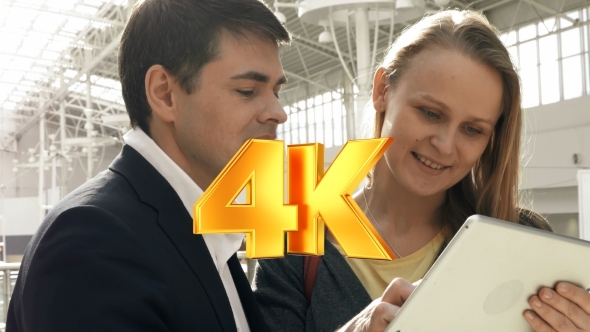 Young Happy Man And Woman Talking On Business With